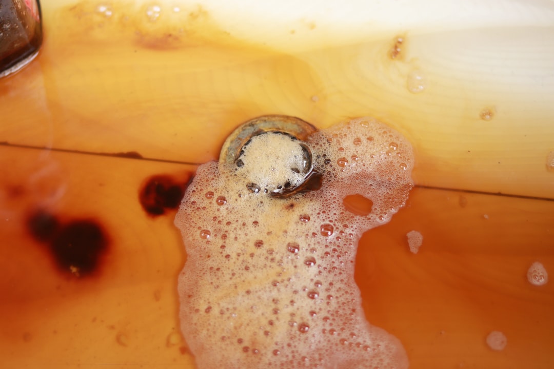 Plumber inspecting a slow drain in a Victoria BC home